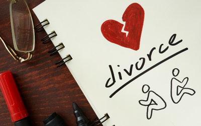 Drawing pad with the word divorce written on it and a broken red heart.